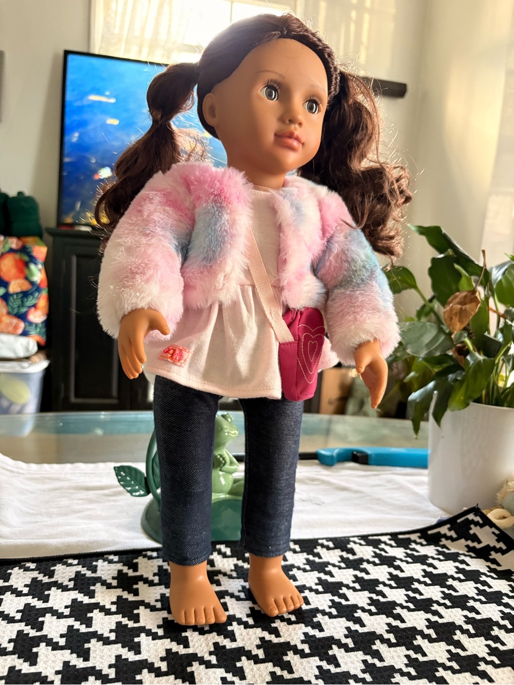 an 18-inch Our Generation fashion doll wearing a colorful faux-fur jacket.